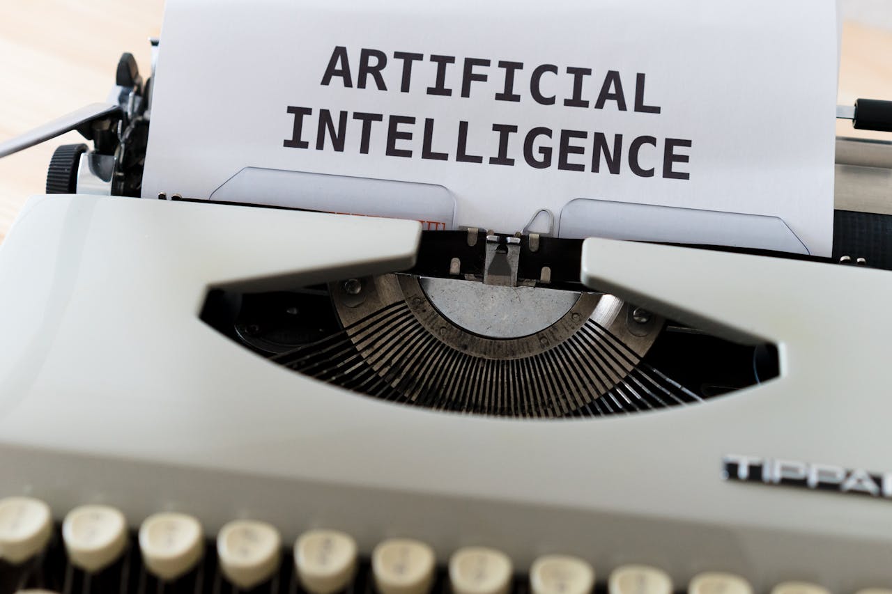 our-experience A close-up of a typewriter showcasing 'ARTIFICIAL INTELLIGENCE' on paper.